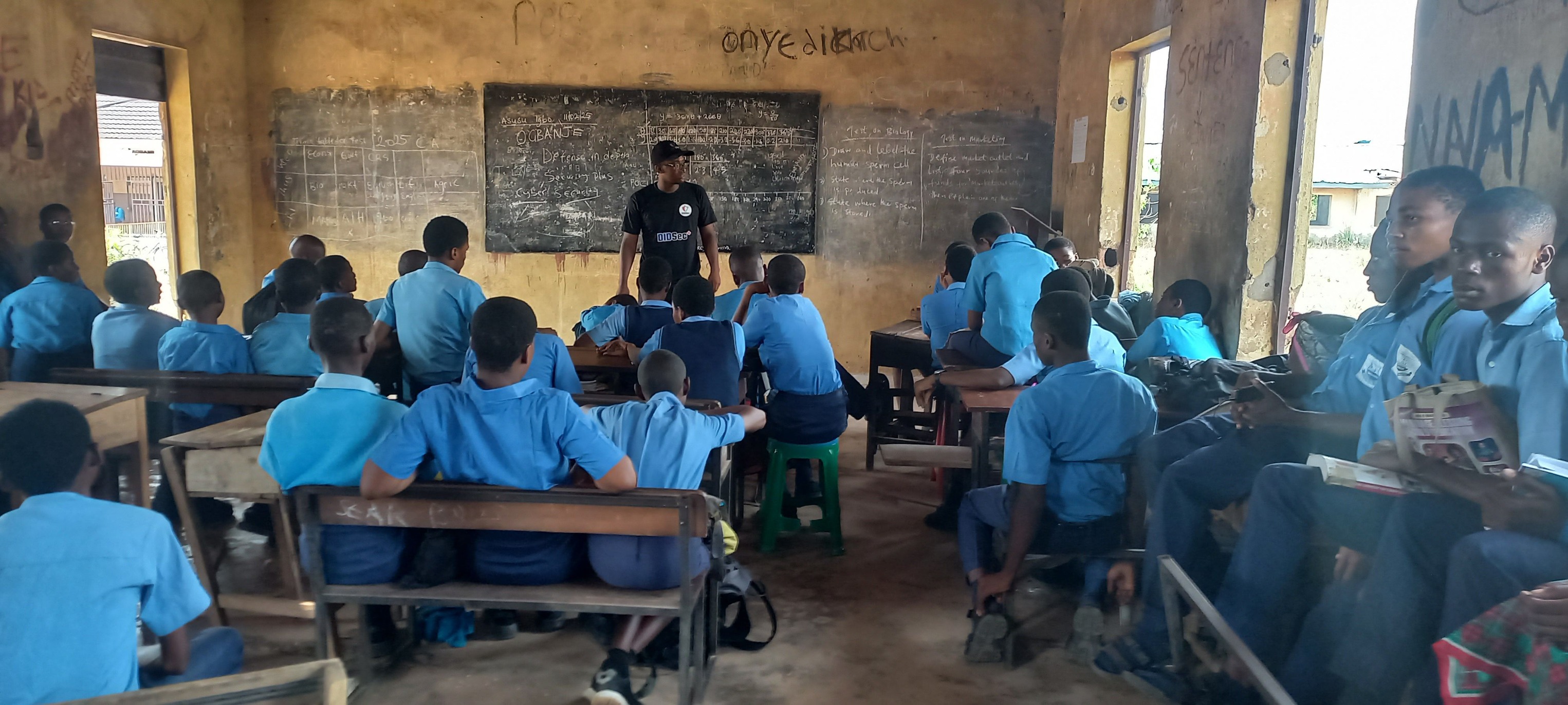 DIDSec+ presenter at the blackboard with Ibeku High School students